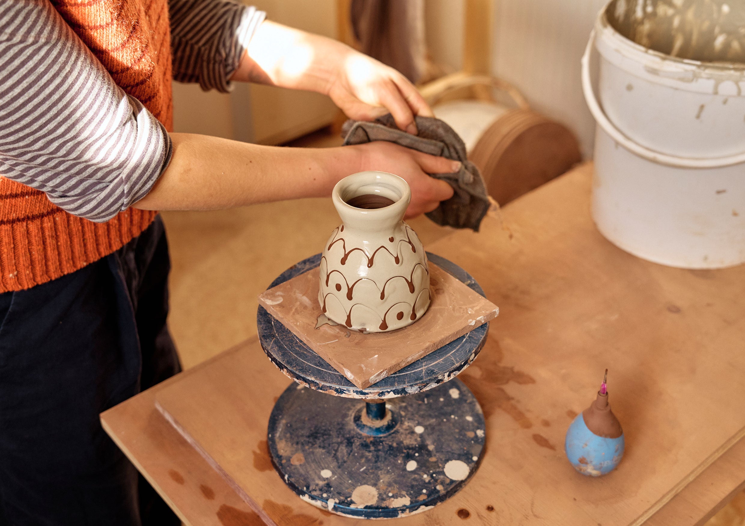 A potter doing slipware decoration.