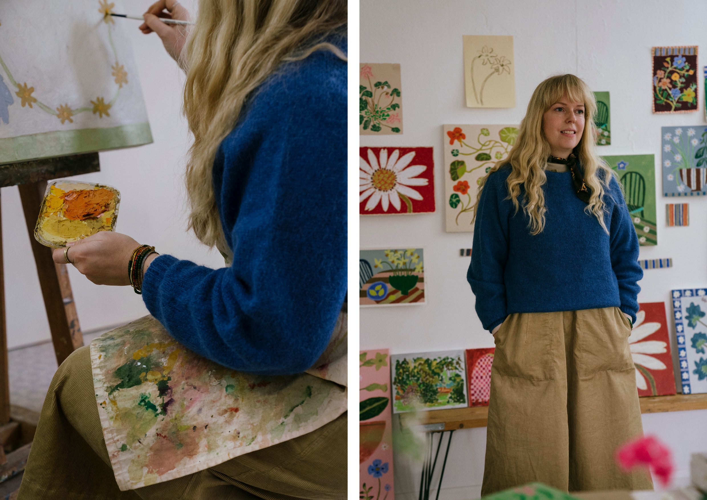 An artist wearing a blue jumper, painting in her studio