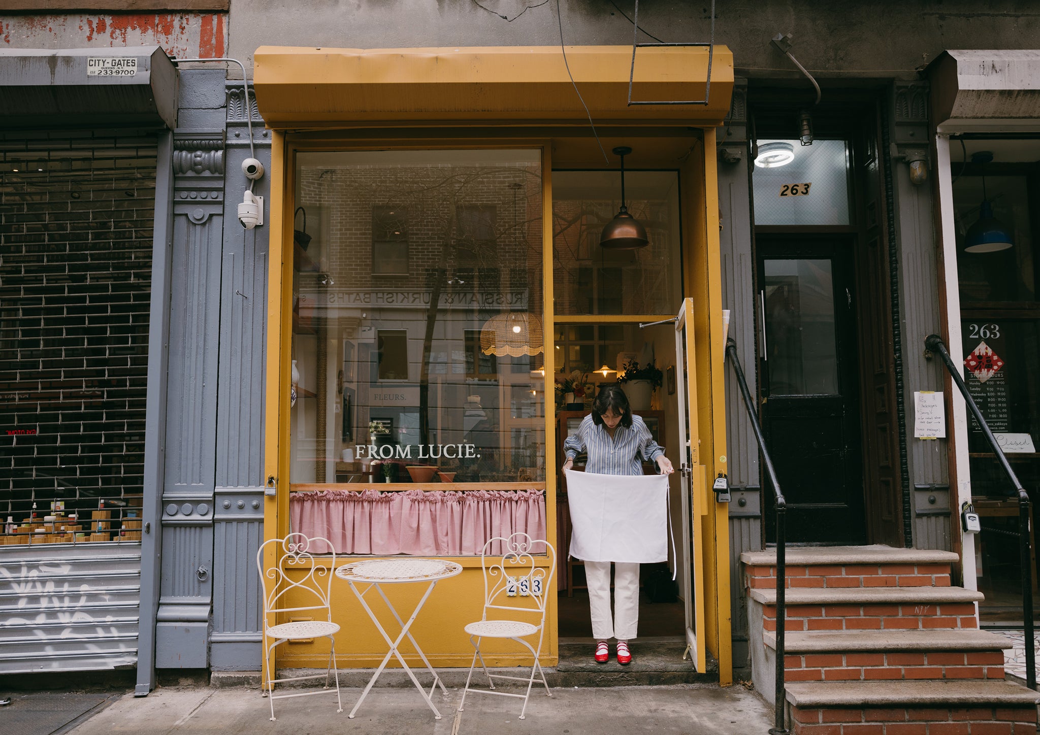 Street view of the front of a yellow bakery.