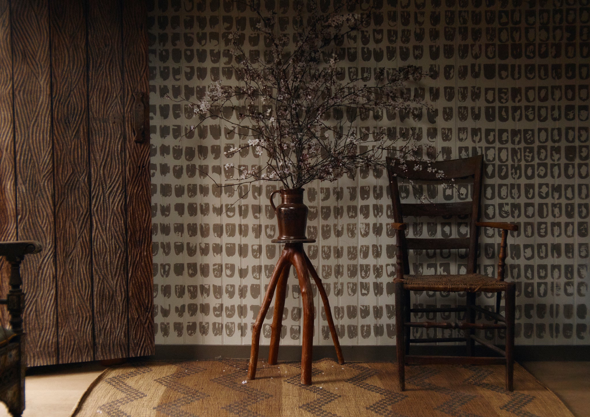 Patterned wallpaper and wooden furniture.