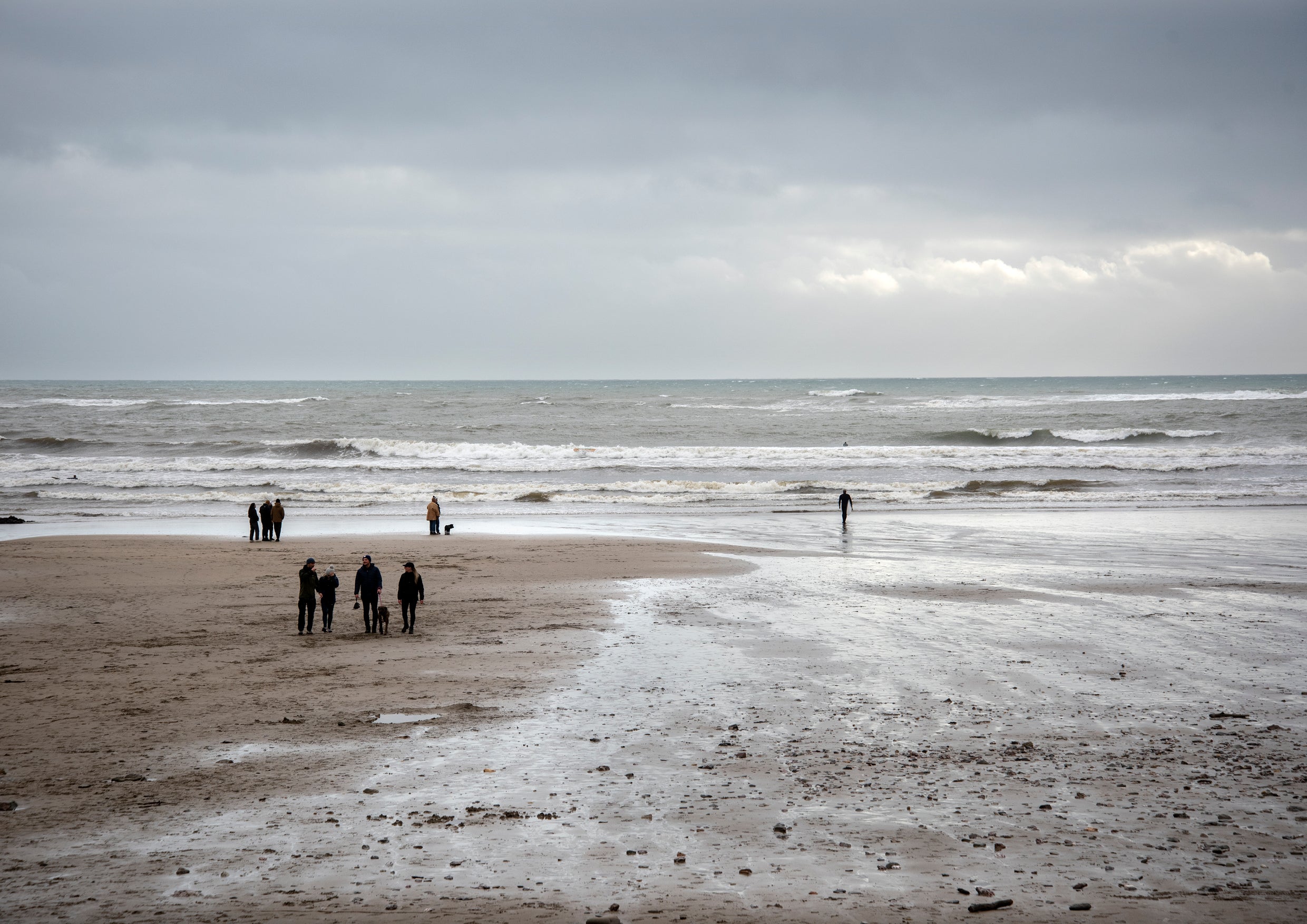 People walking on a beach in winter