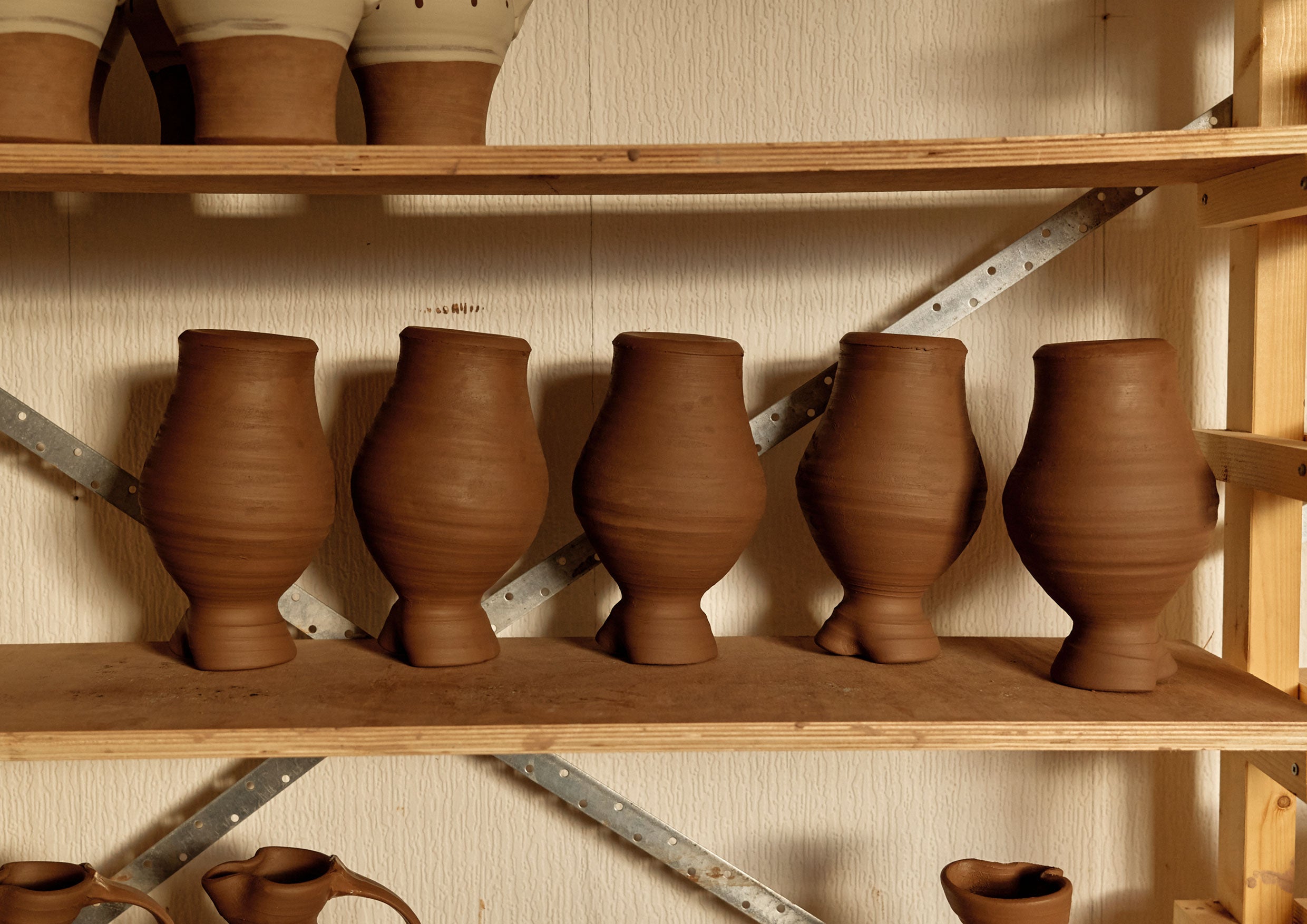 Pots drying on a shelf.