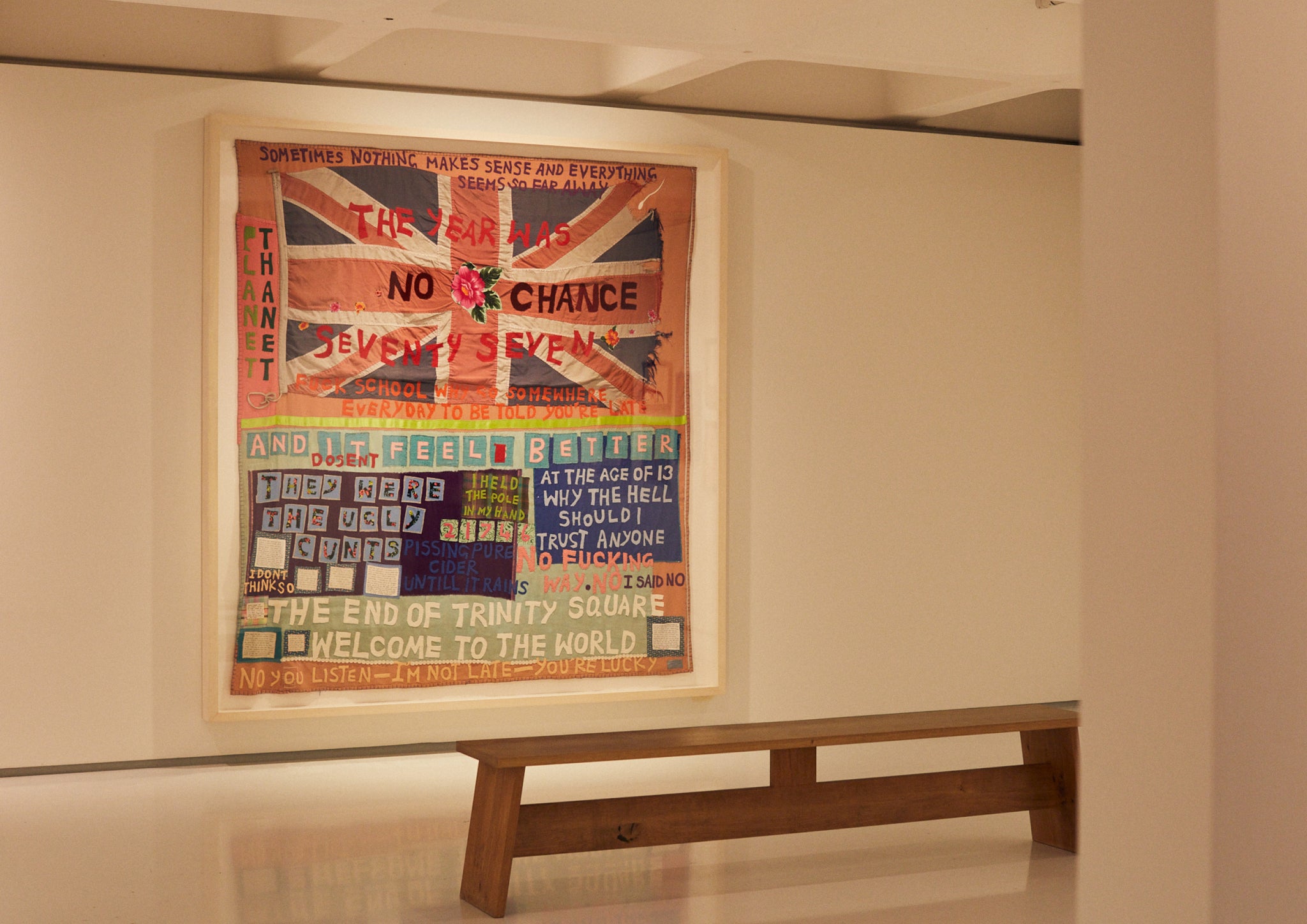 Textile hanging on a wall in an art gallery.