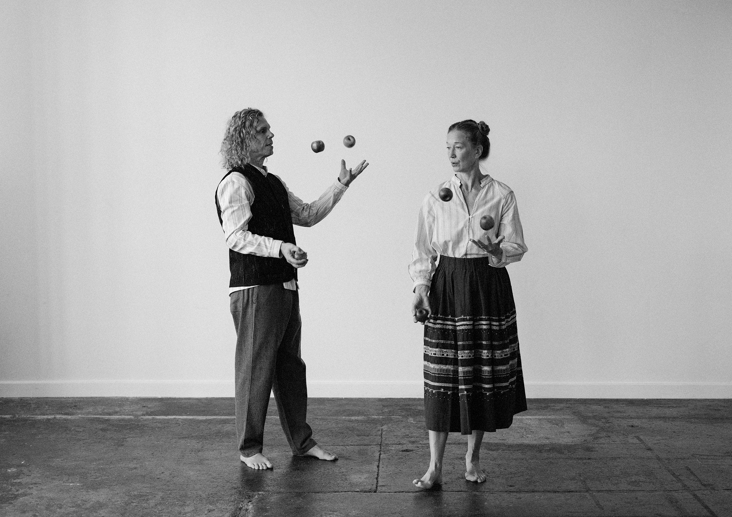Black and white photograph of two jugglers