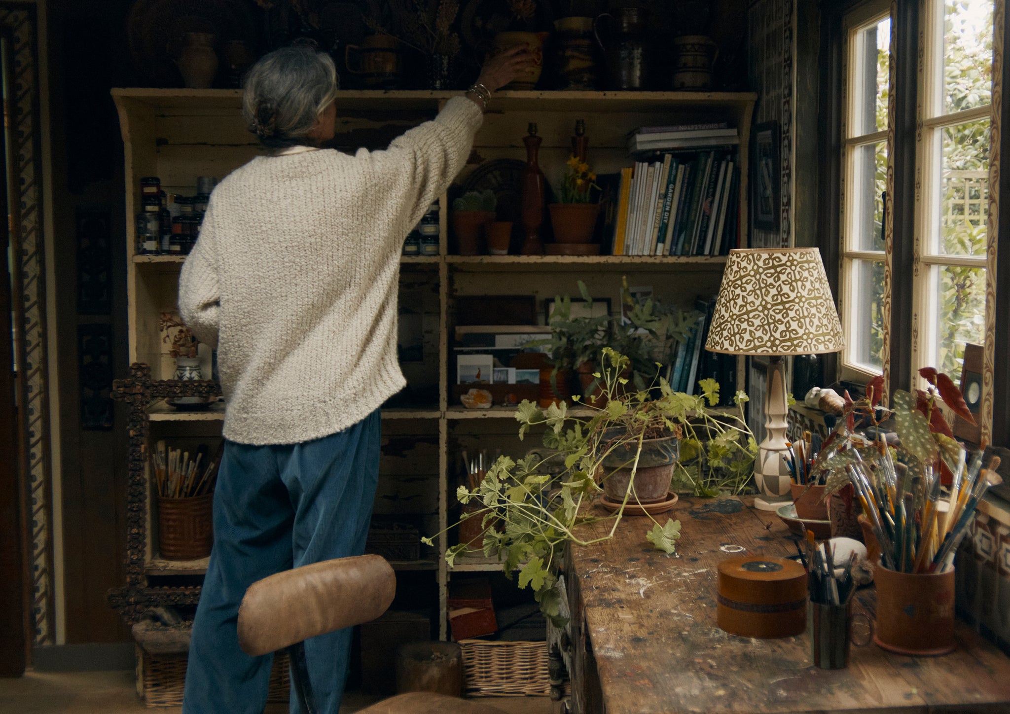 Woman reaching to a shelf