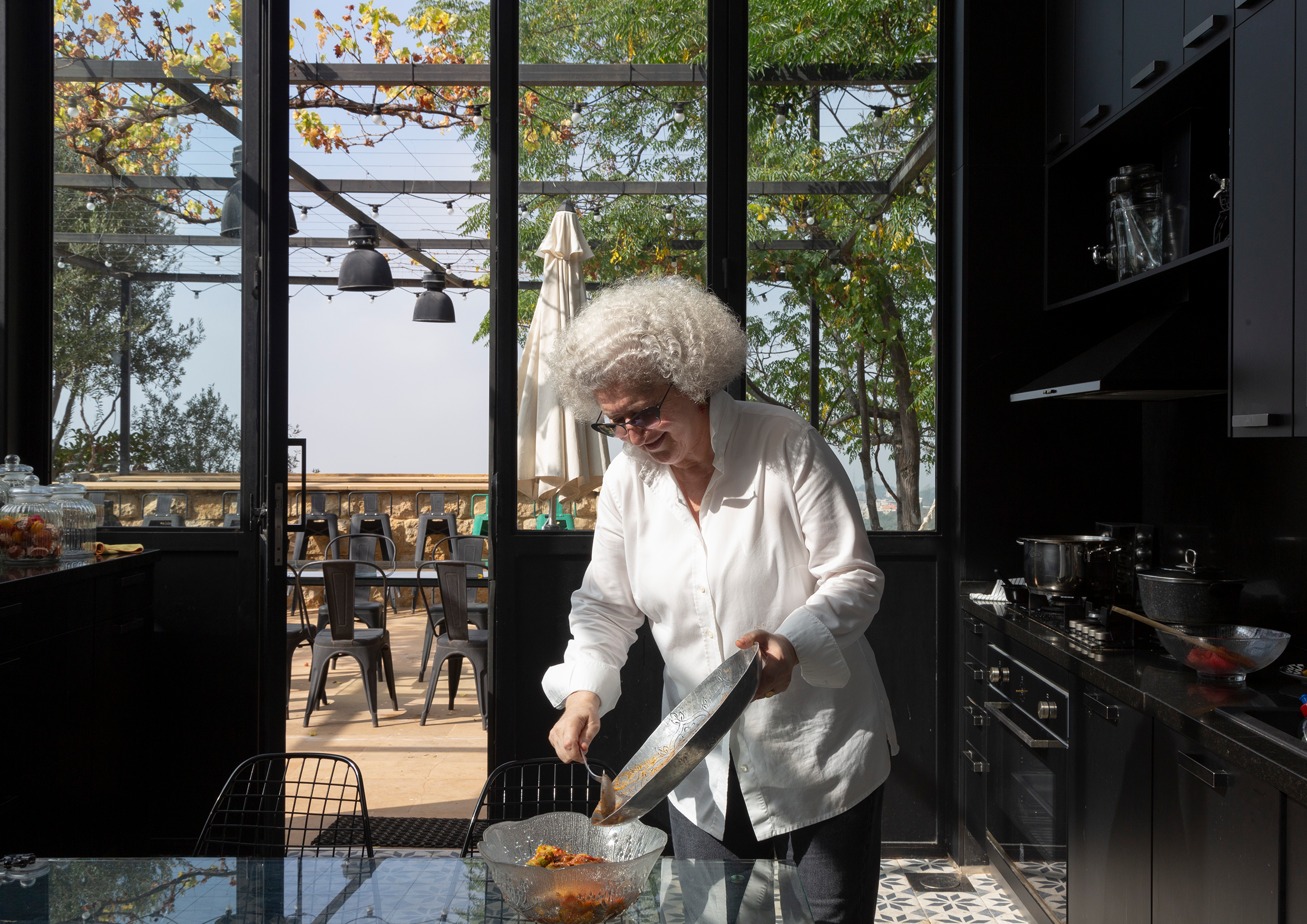 Woman serving food in kitchen