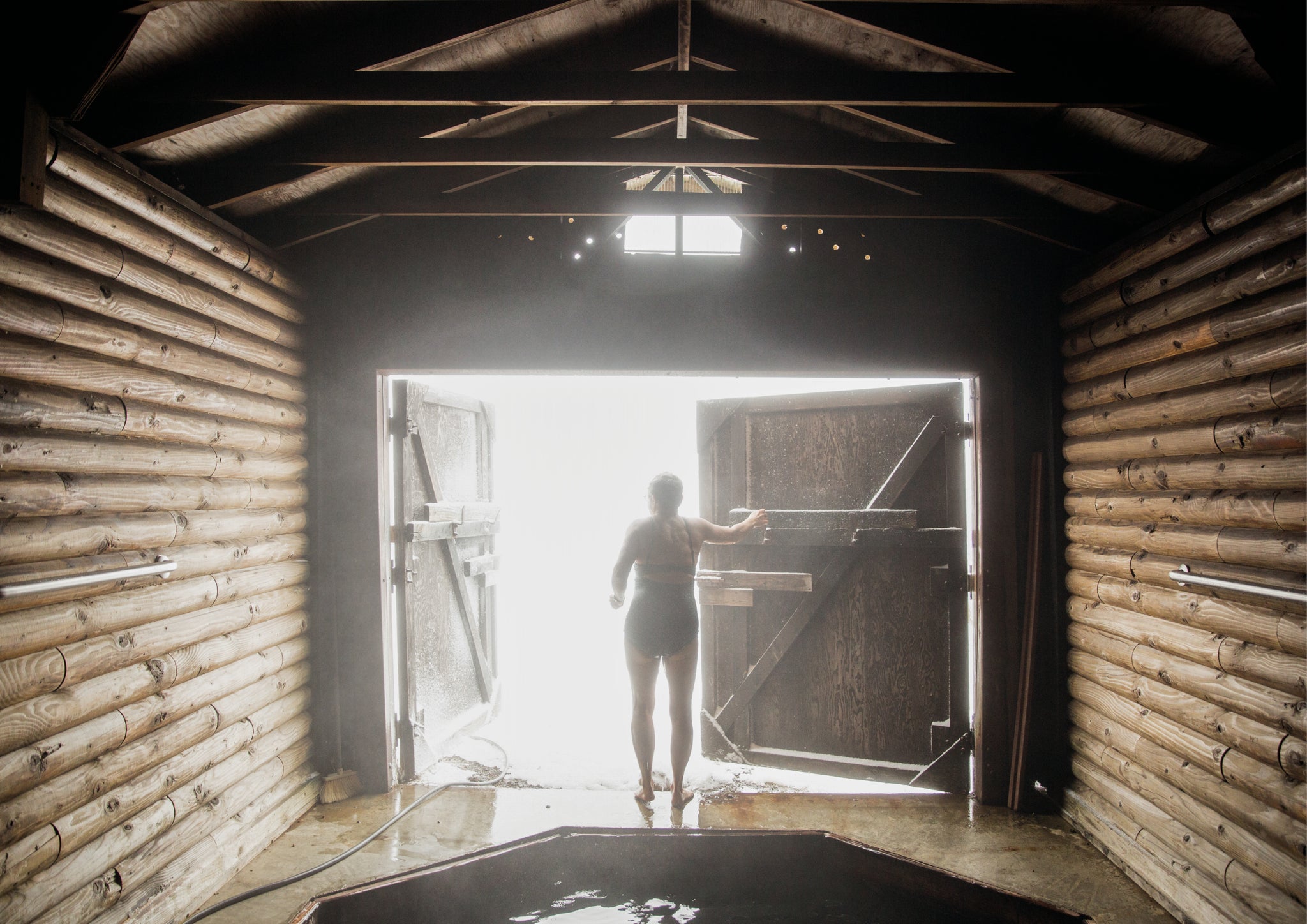 Woman stood by open door