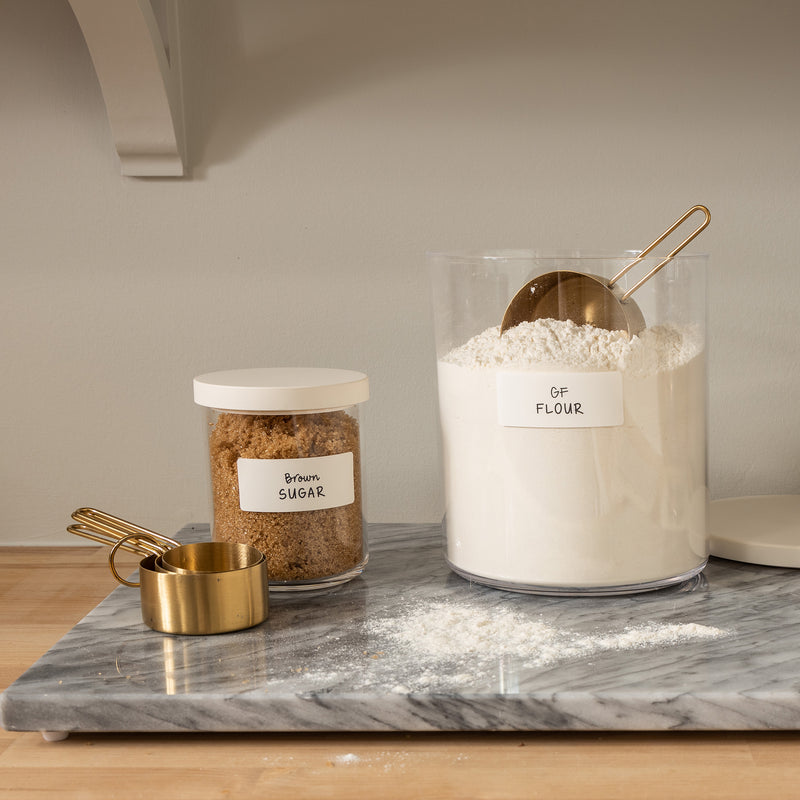 canisters of flour and brown sugar with white removable labels for organizing