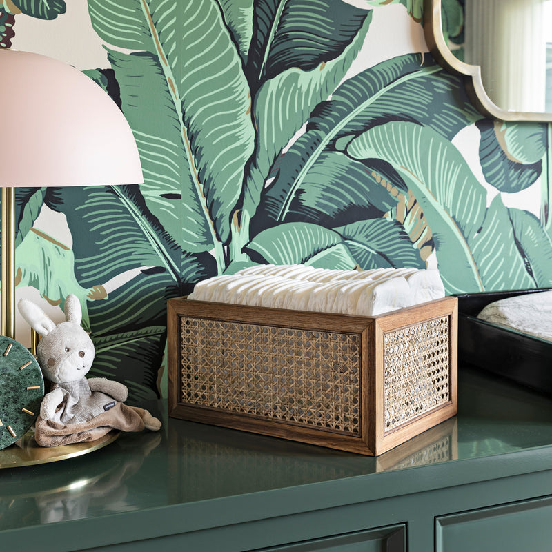 rattan basket with acacia wood frame holding diapers in a nursery