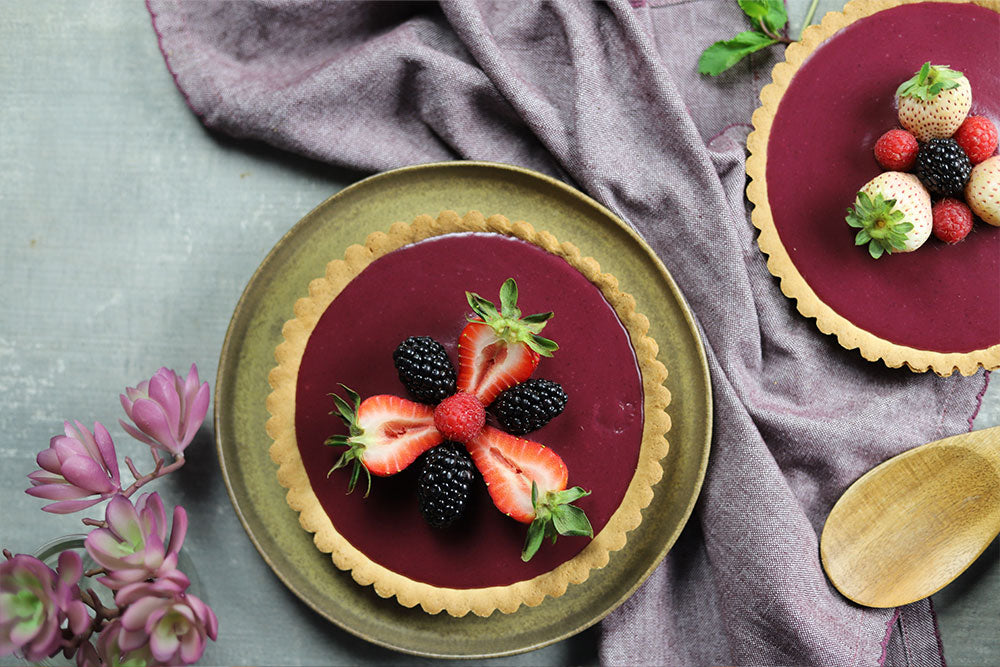 Image of Blackberry White Chocolate Ganache Tarts garnished with fresh berries