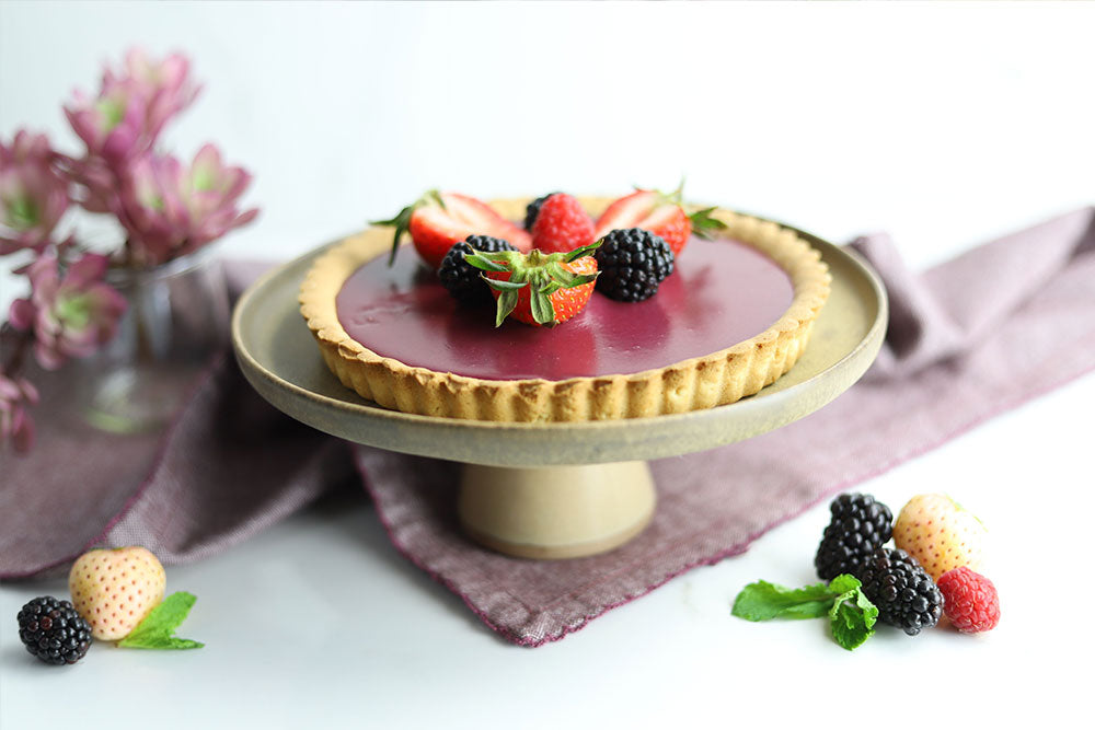 Image of Blackberry White Chocolate Ganache Tarts garnished with fresh berries