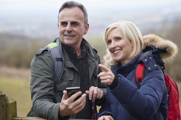 Mature couple using a self guided tour app to navigate outdoors