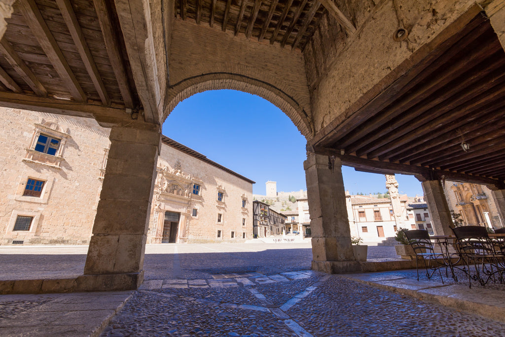 View into a Spanish plaza from under an archway