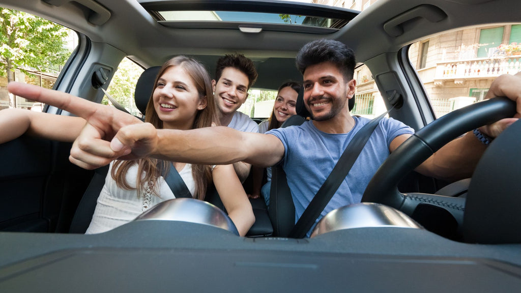 Group of friends in a car on a driving tour