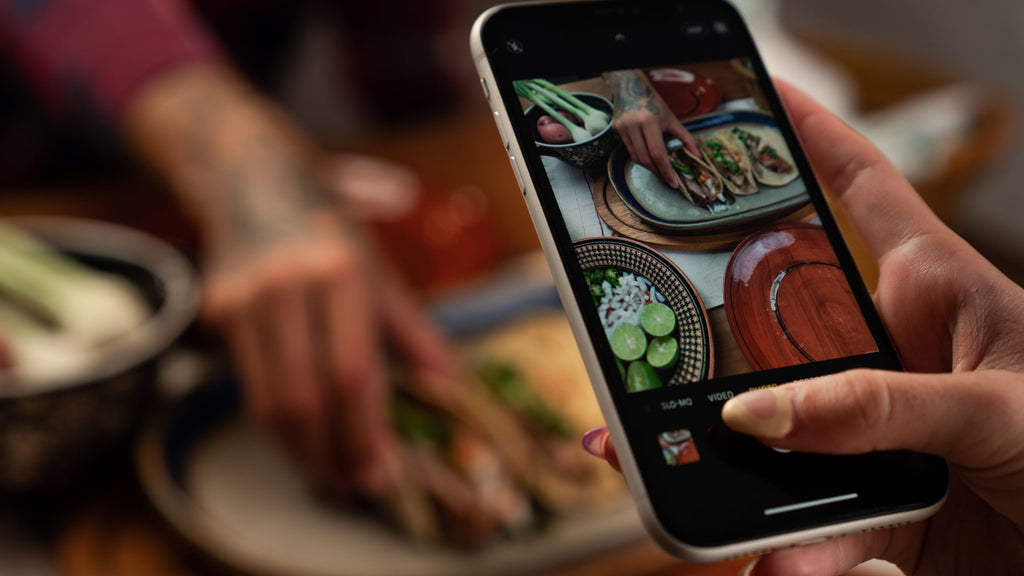 Photo of varied food being taken on a mobile phone