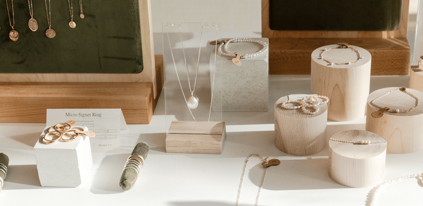 Display of GLDN jewelry and signage at popup event