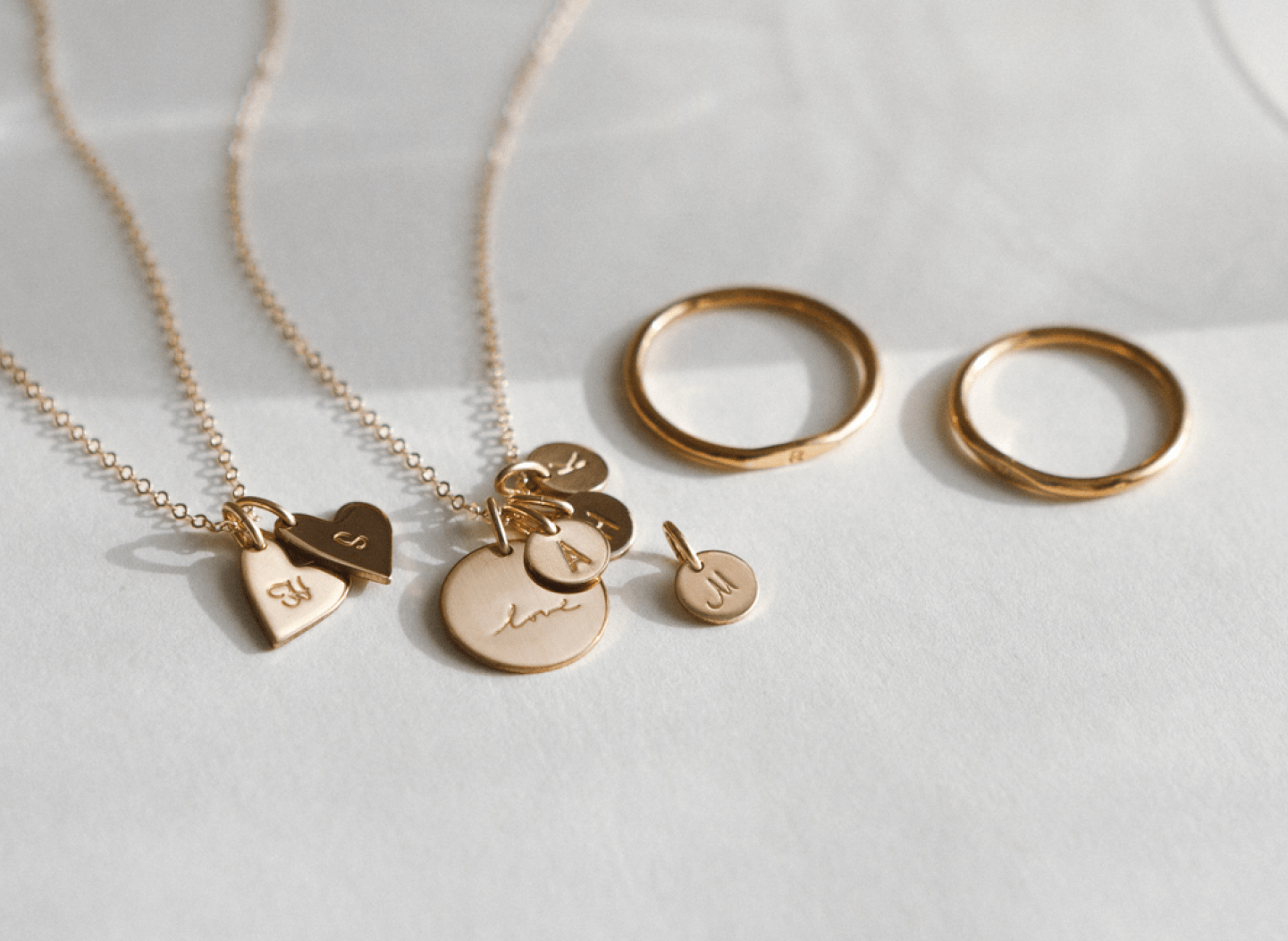 From left: Maude Heart Necklace, Bennett Necklace & Extra Yue Tag, Micro Signet Ring