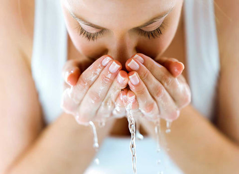 Lady cleansing face