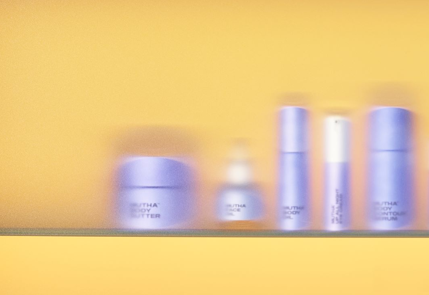 Blurry photo of MUTHA products in a blue cabinet with yellow lighting.