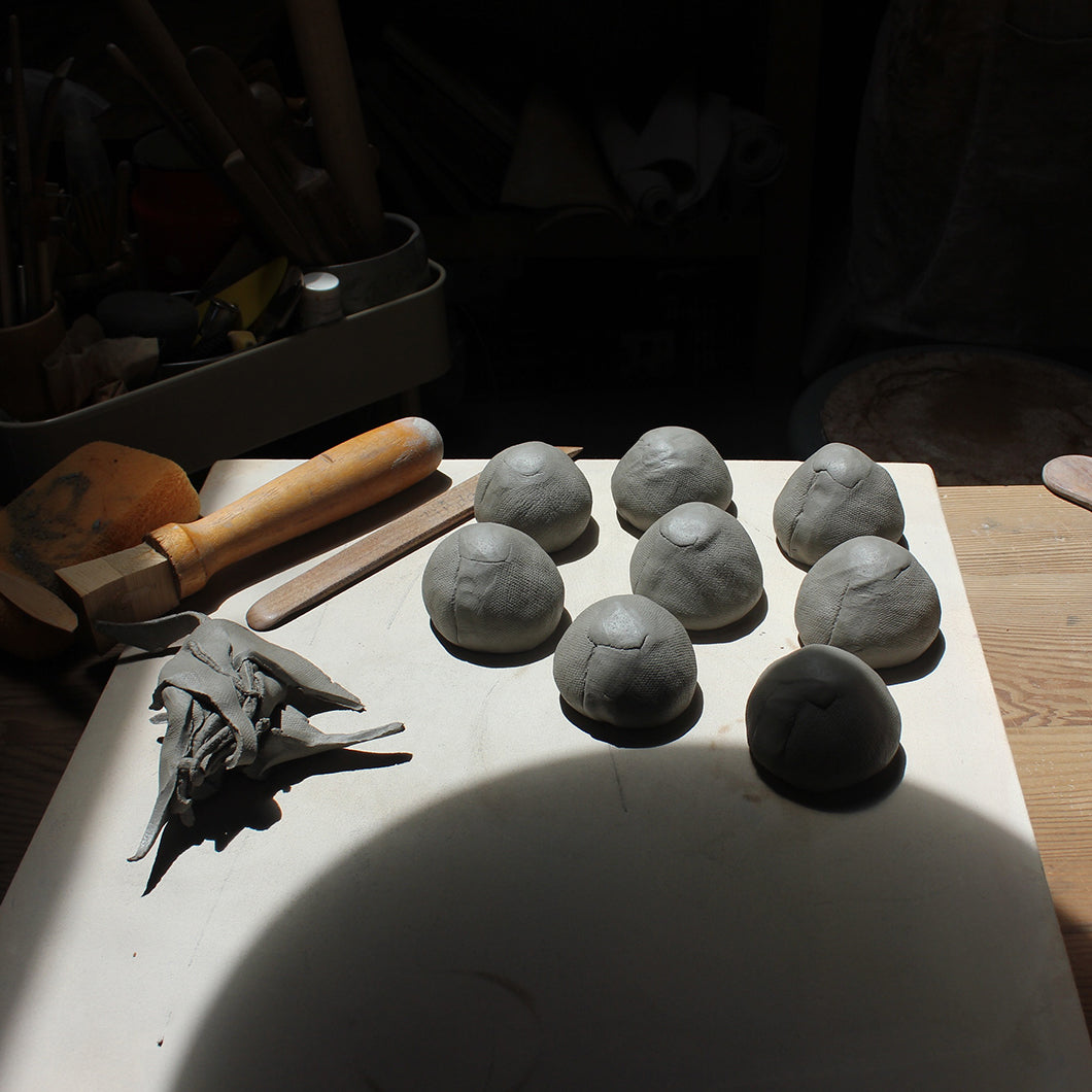 Linda's unfinished clay figurines on her worktable.
