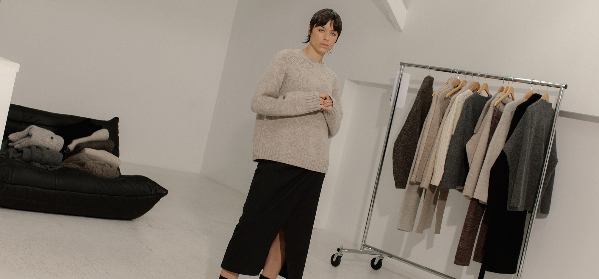 Model wearing cozy knit sweater standing in Bare Knitwear show room