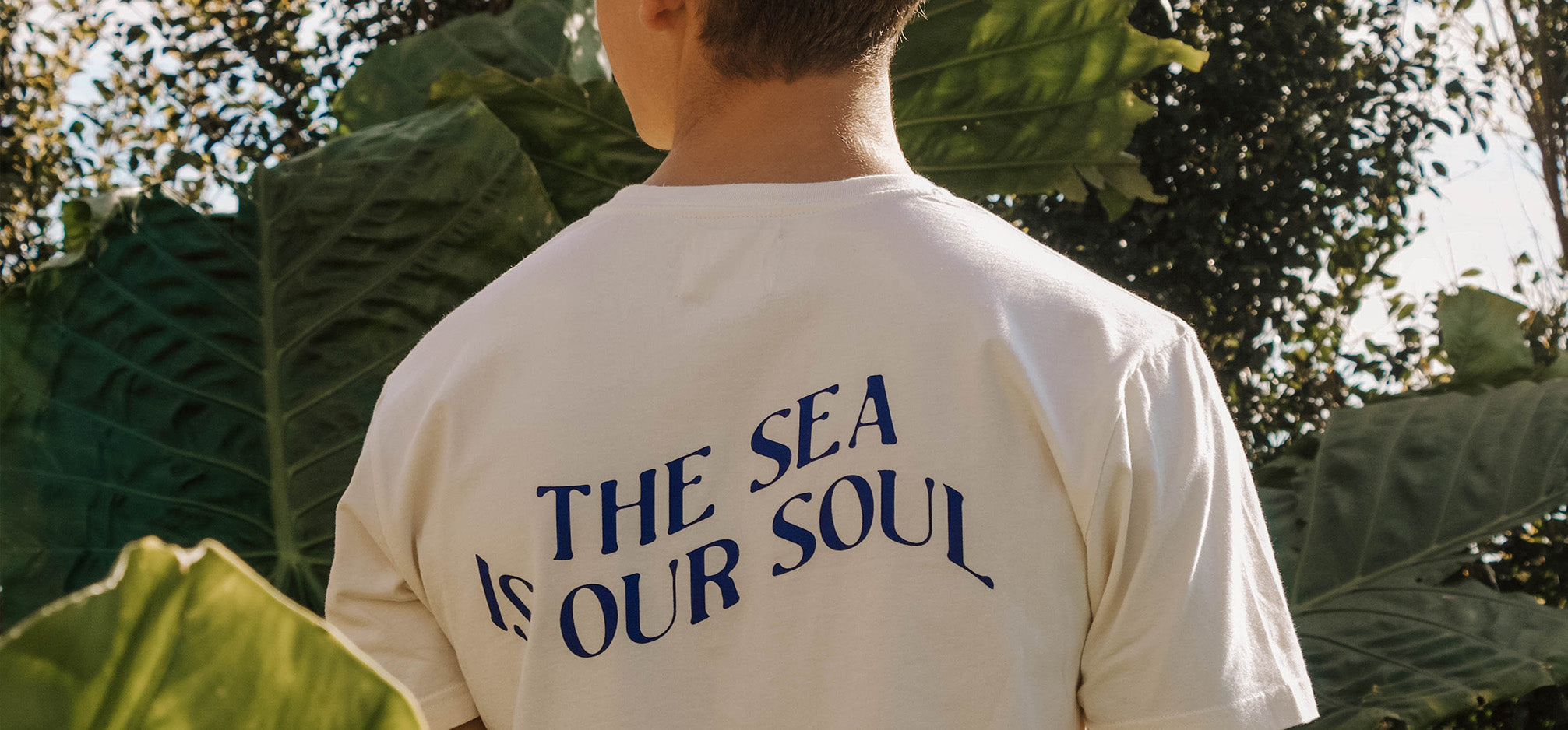 Image of man wearing white t-shirt saying the sea is our soul