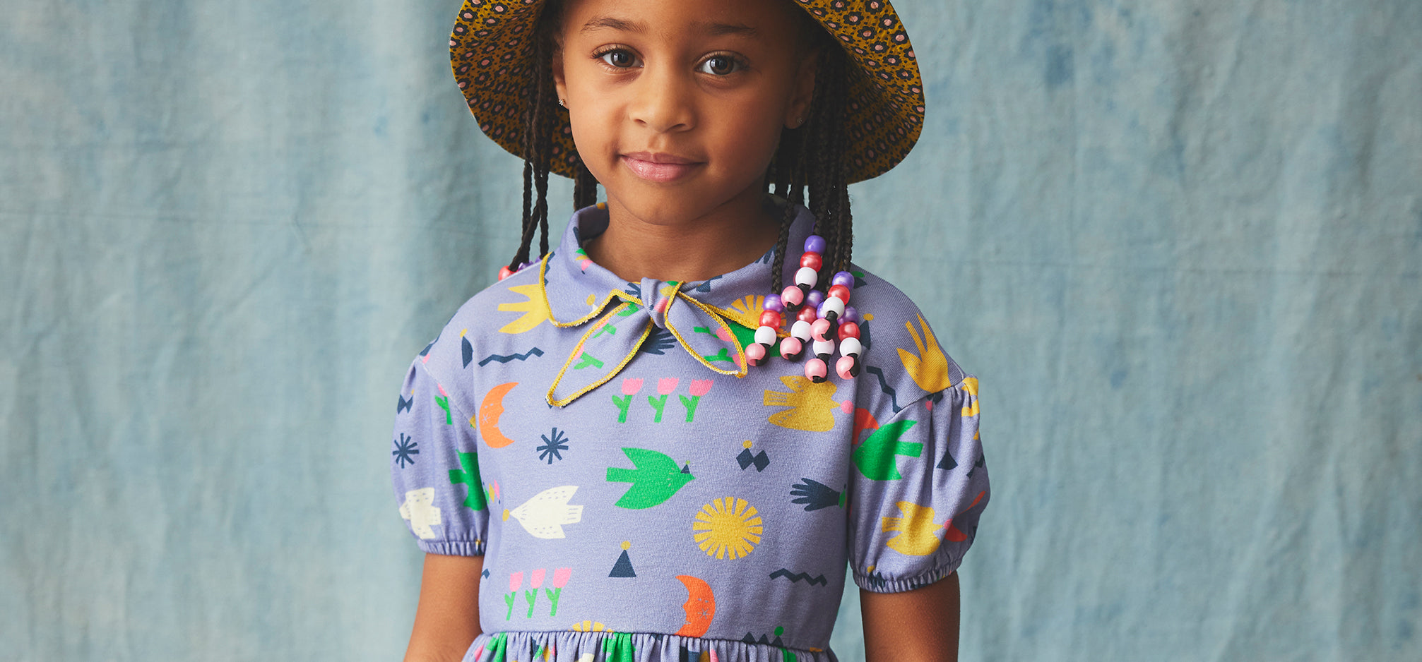 Child wearing Misha & puff purple dress