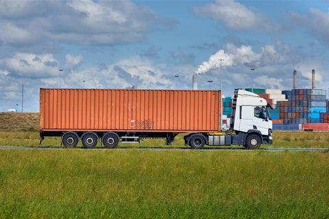 LTL semi truck pulling into shipping harbor