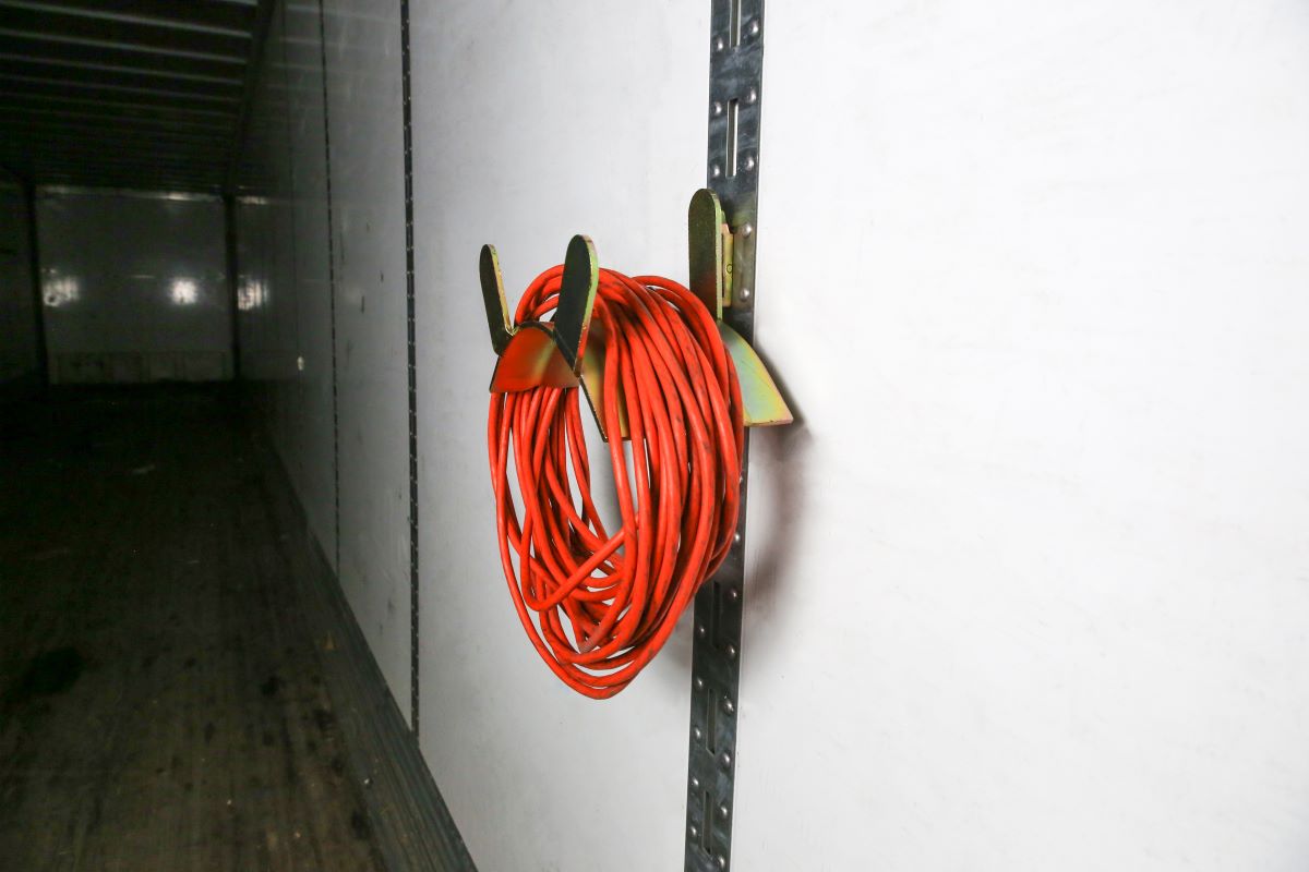 vertical e-track cord holder for enclosed van trailer