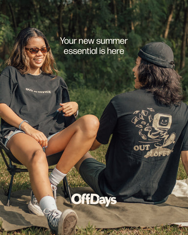 two friends hanging out in the field in a black graphic t shirt
