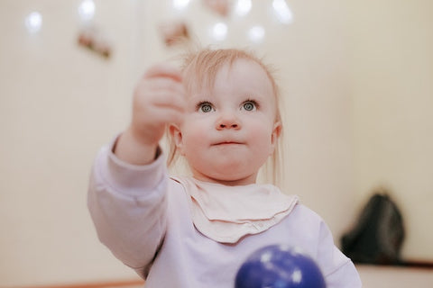 Baby holding a ball