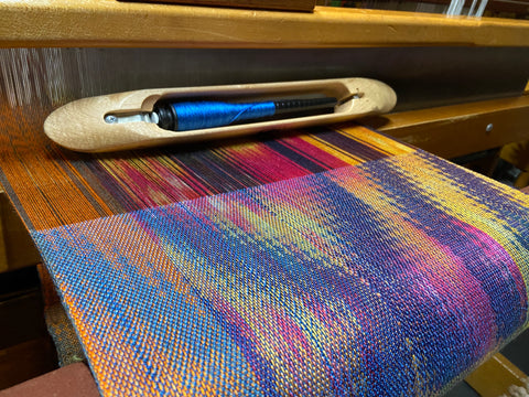 Brightly colored weaving in yelllow, navy, neon orange and blue. 