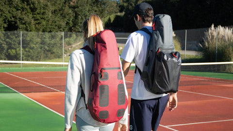 Two tennis players wearing Cancha Bags