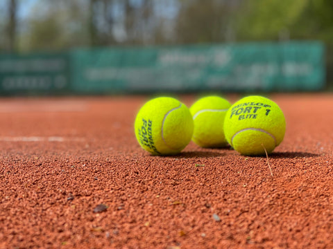 tennis balls on tennis court