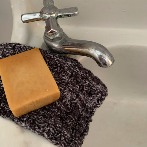 washcloth with soap resting on a sink