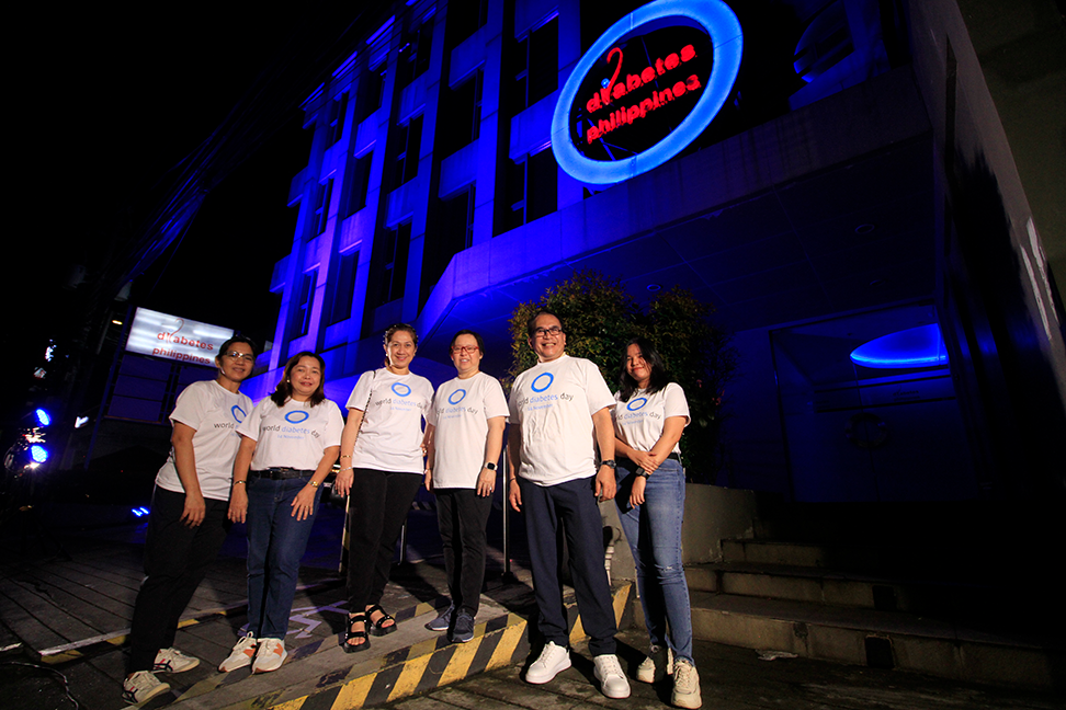 World Diabetes Day in Philippines building lit up in blue with supporters outside.