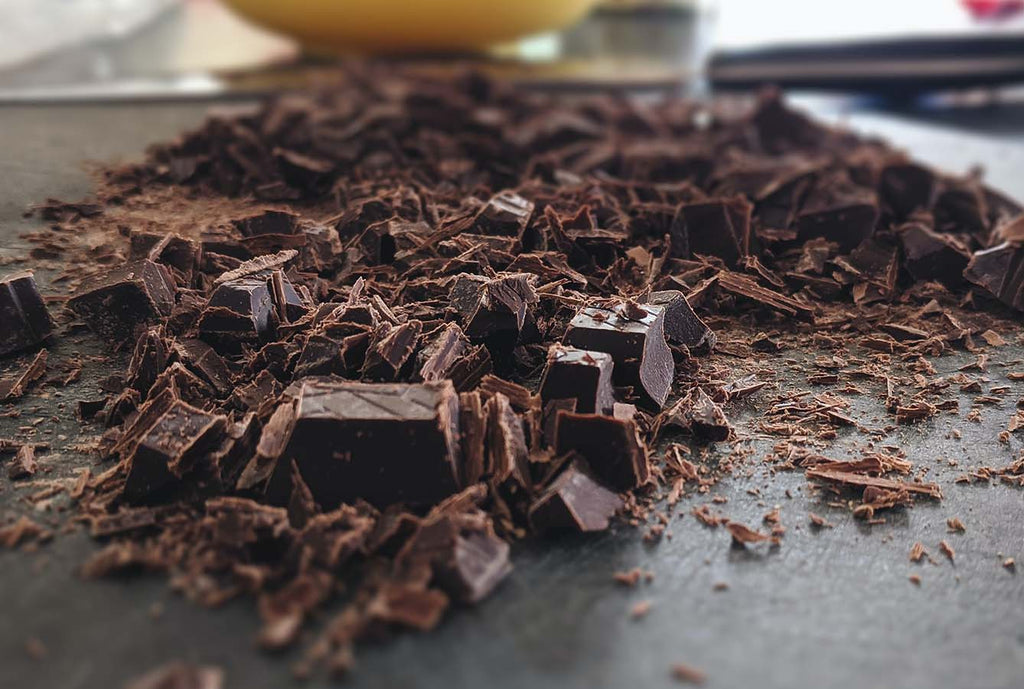 Dark chocolate on table, broken pieces.