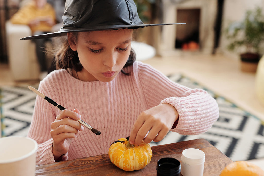 Girl making halloween decorations