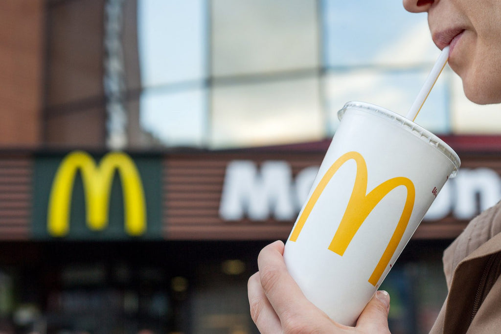 Person outside McDonalds having a drink.