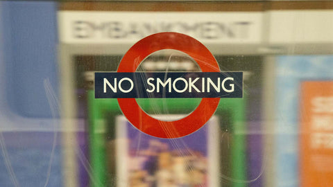 No smoking sign on London Underground tube window.