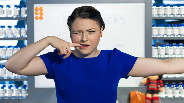 Jade Byrne performing in Pricks the Play with finger in mouth.