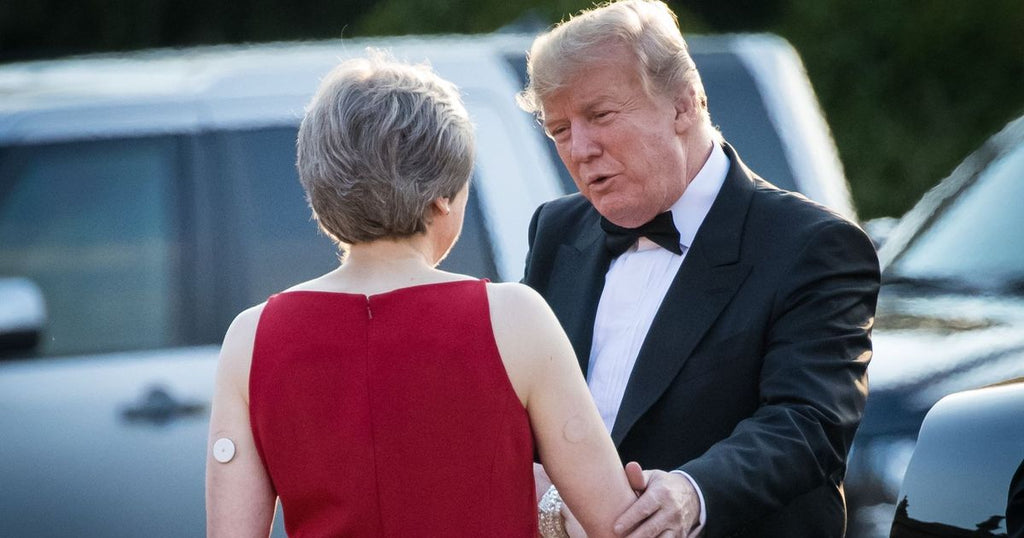 Photo of Theresa May wearing Libre sensor CGM on upper arm being greeted by Donald Trump.