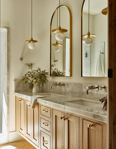 brushed brass light used over marble vanity