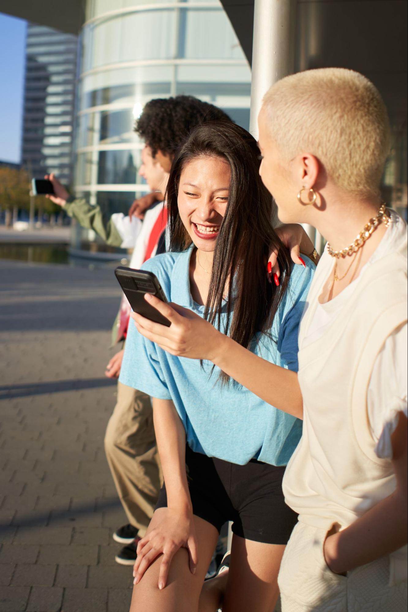 Two people looking at a phone