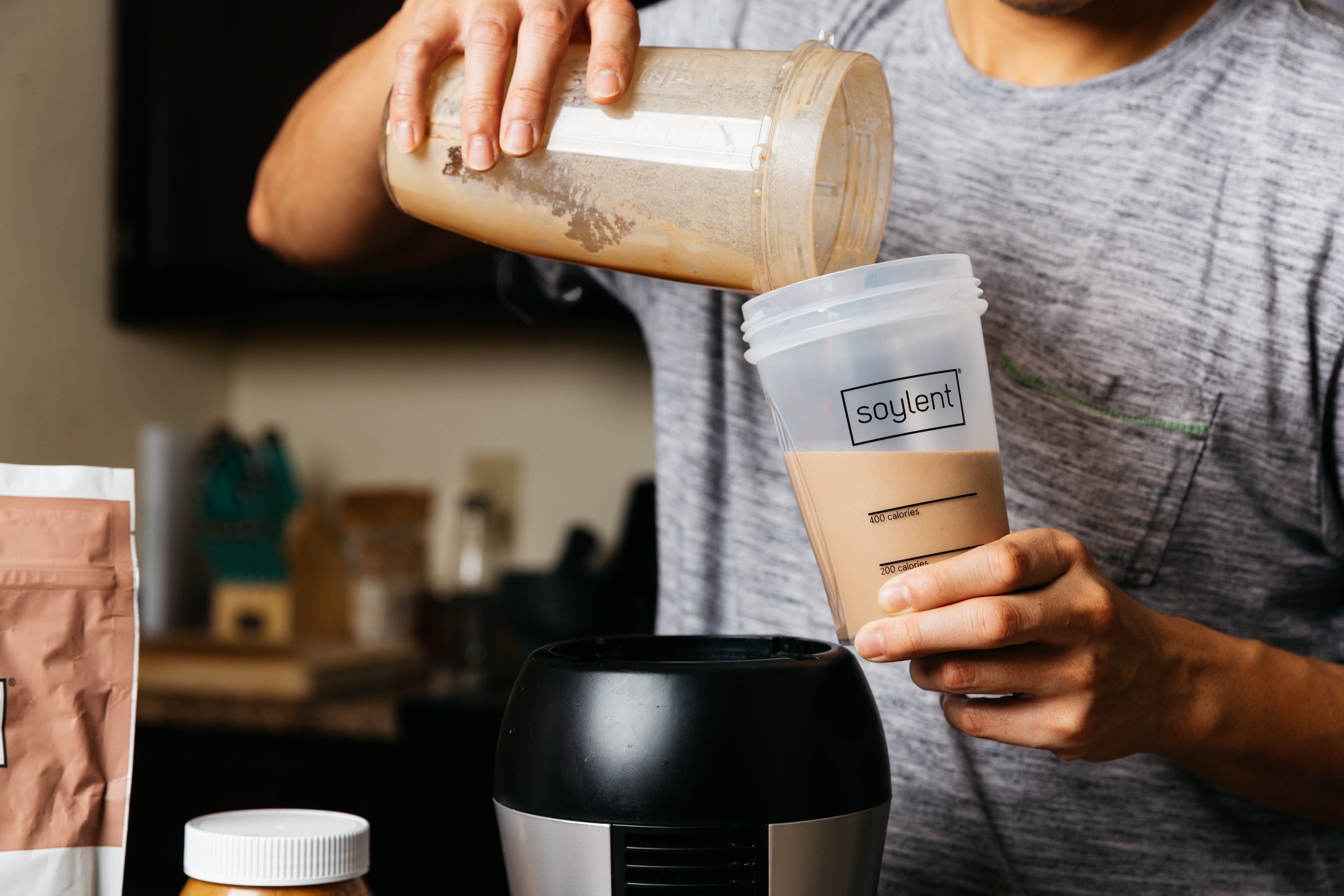 Image of person pouring Soylent into a new cup