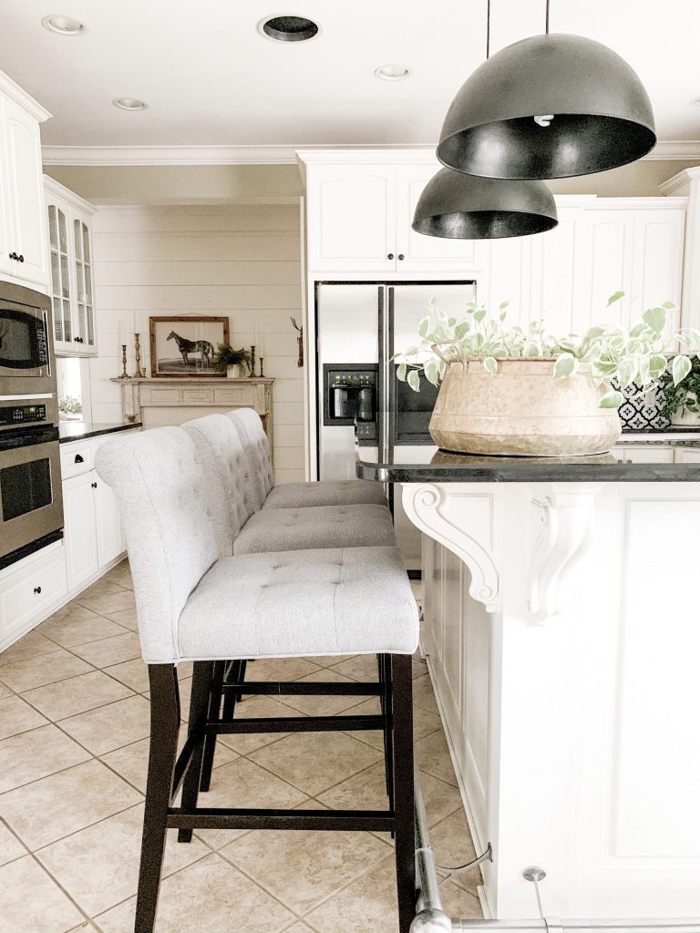 three grey barstools at kitchen island.