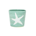 Teal ceramic planter with white starfish design