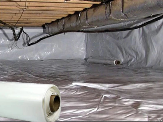 A white roll of crawl space encapsulation being installed