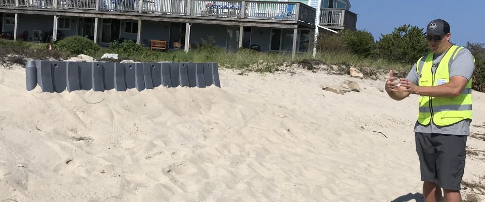 Grey Muscle Wall buried under sand on a beach