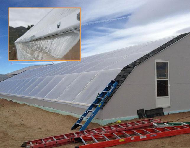 Greenhouse with slanted roof and Solawrap plastic roll sheeting